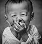 A young boy laughing: 