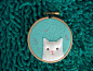 kitty on embroidery loop.... orange kitty on green background or gray kitty on ? background... what would look good?