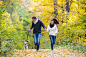 Beautiful young couple with dog running in autumn forest by Jozef Polc on 500px