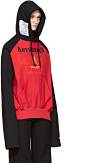 Vetements - Red & Black Champion Edition Antwerpen Hoodie : Long sleeve French terry hoodie colorblocked in red and black. Logo patch and drawstring at hood. Text graphic printed in black and tan at front. Kangaroo pocket at waist. Overlong raglan sle