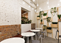 Baranova Pokorsky creates plant-filled cafe in St Petersburg : Baranova Pokorsky has transformed a Soviet-era furniture store into a vegetarian coffee shop, pairing simple materials with plant-lined shelves