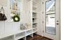 gray and white floral throw pillow beside rack inside room