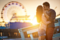 Photograph romantic couple kissing at sunset in front of santa monica ferris wheel. by Joshua Resnick on 500px