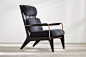 black high-backed chair with black wool upholstery and brass arms