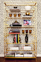 Gold shelves and dalmatian wallpaper.