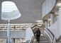 Hiscox office building by Make Architects features grand staircase and Soviet rocket : A decommissioned Soviet rocket is at the centre of this sculptural cast-concrete office in York, England, designed by Make Architects for Hiscox