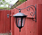 MUST DO! Dollar store solar lights on plant hook - LOVE this idea. Back yard