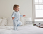 Smiling baby walking on bed : Foto stock