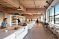 Oficinas para Simple / Hacker Architects | Dis-Up! : Una paleta de materiales mínima enfatiza la estructura de madera del edificio mientras la iluminación, los muebles y las alfombras se seleccionaron para crear un ambiente informal