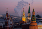 a large clock tower towering over a city: The Kremlin, viewed from the O2 Lounge restaurant, on the roof of the Ritz-Carlton hotel, in Moscow, Russia, on Friday, Dec. 11, 2020. Russia's household consumption is rebounding from a steep plunge in the second