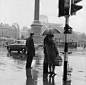 Moore/Stringer
Pedestrians wait to cross the street on a rainy day in Trafalgar Square, London.  1962