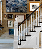 The stair hall functions as a gallery. Carpet from ABC Carpet & Home.

