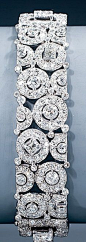 A magnificent Art Deco diamond bracelet by Cartier. Of an unusual geometric design of circles and squares, set with baguette cut, square cut, single cut and old European cut diamonds, mounted in platinum, Paris, circa 1928-1930, signed CARTIER and numbere