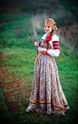 Russian traditional costume of an unmarried peasant girl: an embroidered blouse, a sarafan (a kind of a sleeveless dress) and a nice headband (only married women wore kokoshniks).