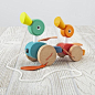 Shop Janod Duck Pull Toy.  Pull the string and watch the wooden duck family stroll forward.  They feature eye-catching colors and take a step in the right direction with each pull.