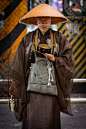 japanese buddhist monk waiting patiently for donations outside the ueno train station, tokyo