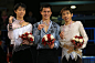 Patrick Chan of Canada with the gold medal celebrates on the podium with silver medalist Yuzuru Hanyu of Japan and bronze medalist Nobunari Oda of...