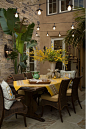 Bright color and European architectural detail combined with wicker and iron create and eclectic outdoor living space.