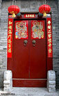 duilian (couplet) written on red paper are posted on each side of the front door to celebrate the new year...