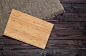 Empty cutting board on dark wooden planks food background concept by Max Lashcheuski on 500px