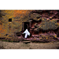 A woman enters an ancient medieval church that is carved into solid rock in Lalibela, Ethiopia. Lalibela is famous for their monolithic rock-cut churches. The churches themselves date from the seventh to thirteenth centuries, and were declared a UNESCO Wo