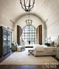 The 18-foot barrel-vault ceiling in the master bedroom is more dimensional thanks to antique-finished wooden boards. Judy Long, a decorator friend of Lisa and Michael, devised the solution for arched door shutters for privacy and to protect from harsh lig