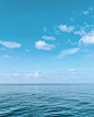 blue body of water under blue and white sky during daytime