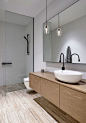 Lighting inside the white contemporary bathroom is kept minimal - Decoist: 