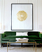 Green sofa with art.