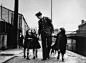 An American soldier with war orphans ‘adopted’ by his unit, London, 1943.