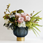 Beautiful in shades of blue and pink, this arrangement is extraordinary. Faith roses, tiger mokara orchids, white hydrangea, austrailian fern, with burnt palm fans accents. Its whimsical appearance will captivate anyone and everyone who lays their eyes on