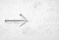 A direction arrow etched in a white wall
