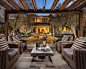 Example of a tuscan backyard patio design in Orange County with a pergola