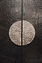 Joseph Giles semi-circle hammered stainless steel pad handles on leather door: 