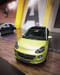 OPEL ADAM Stand Concept : Auto Show stand for a presentation of a single Opel's model the ADAM. Back wall made as six connected boxes with the "ADAM" letters and general description textes on the short sides. The floor panels has highlighted phr