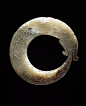 ca. 1100-1000 BCE. Carved Jade Pendant, Coiled Dragon with tail in its mouth. Such items were buried with the owner. Western Zhou Dynasty. China. V&A (C.T. Loo, no find spot): 