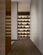 Ubik walk-in closet with wall mounted panels in latte mat lacquered Skin melamine, shoe shelves in cenere oak melamine.