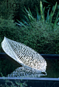 New Zealand garden. Silver-Gilt flora. Metal leaf sculpture by Virginia King floating on water. Xanthe White RHS Chelsea Show 2006. Contemporary Ornaments Ponds Jerry Harpur Please read our licence terms. All digital images must be destroyed unless otherw