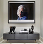 A Large-format photograph of Marilyn Monroe, by Lawrence Schiller, hangs above a low, dark-grey cabinet with brass feet by BDDW. Vintage Swedish pottery and a bronze sculpture lank either end of the sideboard.
