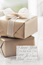 Brown gifts with a white tie and a note Free Photo
