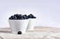 Black Round Fruit on White Ceramic Bowl