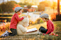 Two adorable little boys with his teddy bear friend in the park by Tatyana Tomsickova