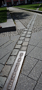 The Berlin Wall is mostly gone, but ghost markers on the ground mark where it once split the city. Photo: Dimster Architecture