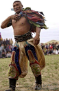 Mongolian wrestler wearing traditional wide trousers 