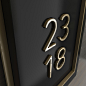   Detail view of a unit number in painted acrylic and brushed brass.  