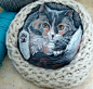 Balled up cat painting on stone