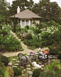 Woman reading newspaper with dog in garden