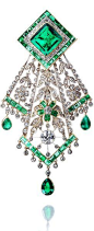 An emerald and diamond handkerchief brooch, circa 1910 The lozenge-shaped surmount set with a step-cut emerald, within borders of old brilliant and single-cut diamonds and calibré-cut emeralds, suspending an openwork floral and foliate pendant designed to