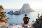 Rear View of Man Sitting on Rock by Sea · Free Stock Photo