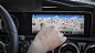 Mercedes-Benz User Experience (MBUX): hand operating touchscreen.